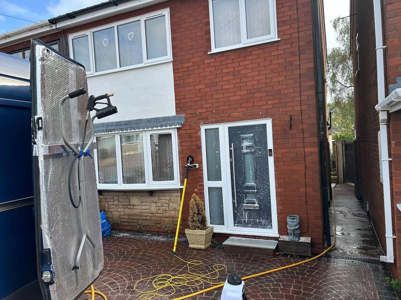 Soft washing a render and brick house exterior